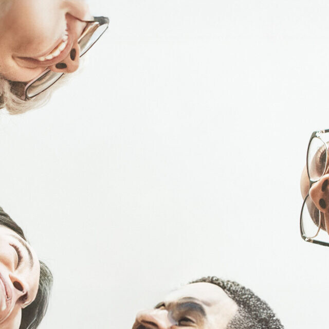 Happy diverse businesswomen huddling in the office